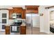 Kitchen features wood cabinetry, stainless steel appliances, and granite countertops at 7413 S Elliott St, Tampa, FL 33616