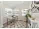Well-lit office area offers neutral paint, two windows and a modern white desk at 7413 S Elliott St, Tampa, FL 33616