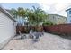 Cozy backyard patio with pavers, landscaping, and comfortable seating around a fire pit at 7413 S Elliott St, Tampa, FL 33616