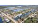 Stunning aerial view showcases waterfront homes nestled among lush greenery, surrounded by canals and waterways at 8084 Burwell Cir, Port Charlotte, FL 33981
