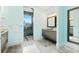 Bathroom featuring double vanities, a walk-in shower, and contemporary fixtures at 8084 Burwell Cir, Port Charlotte, FL 33981
