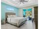 Serene bedroom with a plush bed, soft lighting, and access to the outdoor patio at 8084 Burwell Cir, Port Charlotte, FL 33981