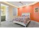 Inviting bedroom with a white bed, floral bedding, modern lighting, and wood-look floors at 8084 Burwell Cir, Port Charlotte, FL 33981