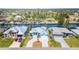 Beautiful waterfront home featuring a gray metal roof, an eye-catching turquoise trim, and a circular driveway at 8084 Burwell Cir, Port Charlotte, FL 33981
