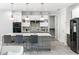 Modern kitchen with a large island, stainless steel appliances, and stylish pendant lighting at 8084 Burwell Cir, Port Charlotte, FL 33981