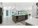 Kitchen with stainless steel appliances, an island with seating, and an open floor plan at 8084 Burwell Cir, Port Charlotte, FL 33981