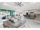 Open living room with modern décor, leading to the dining area and a view of the outdoor pool at 8084 Burwell Cir, Port Charlotte, FL 33981