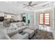 Bright living room featuring modern furnishings, an open layout, and access to the kitchen at 8084 Burwell Cir, Port Charlotte, FL 33981