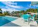 Sparkling pool overlooking a canal lined with tropical foliage at 8084 Burwell Cir, Port Charlotte, FL 33981