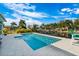 Inviting backyard pool overlooking a tranquil canal with palm trees and lush landscaping at 8084 Burwell Cir, Port Charlotte, FL 33981
