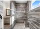Tiled walk-in shower with rainfall shower head, seat, and bright window at 8084 Burwell Cir, Port Charlotte, FL 33981