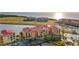 Stunning aerial view of condo buildings, lake, and ocean highlighting the coastal lifestyle and beautiful architecture at 95 Vivante Blvd # 9524, Punta Gorda, FL 33950