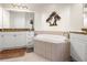 This bright bathroom features a soaking tub, granite counters, and white cabinets at 95 Vivante Blvd # 9524, Punta Gorda, FL 33950