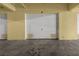 Garage with three garage doors in a yellow wall at 95 Vivante Blvd # 9524, Punta Gorda, FL 33950