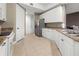 Bright kitchen with stainless steel refrigerator, granite countertops, and ample cabinet space at 95 Vivante Blvd # 9524, Punta Gorda, FL 33950