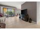Bright living room with tile floors, comfortable sofa, and a sliding door to balcony at 95 Vivante Blvd # 9524, Punta Gorda, FL 33950