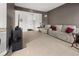 Spacious living room with tile flooring, sofa, television, and sliding glass door for natural light at 95 Vivante Blvd # 9524, Punta Gorda, FL 33950