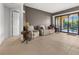Cozy living room featuring neutral tile flooring, sliding glass doors to balcony, and plush armchairs at 95 Vivante Blvd # 9524, Punta Gorda, FL 33950