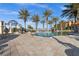 Stunning community pool featuring a gazebo, lounge seating, and tropical landscaping at 95 Vivante Blvd # 204, Punta Gorda, FL 33950
