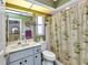 Cozy bathroom with marble countertop, palm tree shower curtain, and decorative coastal accents at 1372 Annette St, Punta Gorda, FL 33980