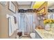 Stylish bathroom featuring decorative elements, vanity, and a tub and shower with a rustic-style shower curtain at 1372 Annette St, Punta Gorda, FL 33980