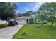 Charming single-story home with a well-manicured lawn, mature trees, and a convenient two-car garage at 1372 Annette St, Punta Gorda, FL 33980