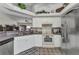 Well-lit kitchen with white cabinets, modern appliances, and unique flooring for a cozy cooking space at 1372 Annette St, Punta Gorda, FL 33980