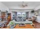 Spacious living room with hardwood floors, large windows, a ceiling fan, and lots of space for entertaining at 1372 Annette St, Punta Gorda, FL 33980