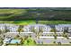 Beautiful aerial view of the complex with parking, pool, and golf course and wetlands in the background at 14061 Heritage Landing Blvd # 445, Punta Gorda, FL 33955