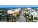 Aerial view of a city street with palm trees, buildings, and a bridge in the distance at 14061 Heritage Landing Blvd # 445, Punta Gorda, FL 33955