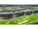 This aerial showcases the community's golf course, lake, and well-maintained residential buildings at 14061 Heritage Landing Blvd # 445, Punta Gorda, FL 33955
