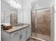 Well-lit bathroom with a granite vanity, a walk-in shower, and tiled floors at 14061 Heritage Landing Blvd # 445, Punta Gorda, FL 33955