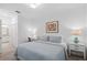 Bedroom featuring neutral tones, a comfortable bed, and a glimpse into the bathroom at 14061 Heritage Landing Blvd # 445, Punta Gorda, FL 33955