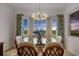 A dining room with stylish decor, a glass table, and picturesque views through large windows at 14061 Heritage Landing Blvd # 445, Punta Gorda, FL 33955