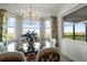 Dining room boasts a glass table, stylish lighting, and scenic views from large windows at 14061 Heritage Landing Blvd # 445, Punta Gorda, FL 33955