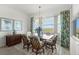 Dining area showcasing a modern chandelier, a glass table, and scenic outdoor views at 14061 Heritage Landing Blvd # 445, Punta Gorda, FL 33955
