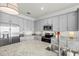 Well-equipped kitchen featuring grey cabinetry, stainless steel appliances, and ample countertop space at 14061 Heritage Landing Blvd # 445, Punta Gorda, FL 33955
