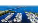 Stunning aerial view of marina with boats, docks, and bridge in the background on the water at 14061 Heritage Landing Blvd # 445, Punta Gorda, FL 33955
