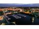 Aerial view of a marina at night with boats docked, city lights reflecting on the water at 14061 Heritage Landing Blvd # 445, Punta Gorda, FL 33955