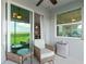 Screened patio features chairs, a small fridge, and views of the surrounding landscape and sky at 14061 Heritage Landing Blvd # 445, Punta Gorda, FL 33955