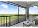 Enjoy the outdoors from the screened patio, overlooking the golf course and expansive landscape, with blue sky at 14061 Heritage Landing Blvd # 445, Punta Gorda, FL 33955