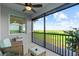 Relax on this screened patio featuring a seating area with scenic views of the lush green landscape and sky at 14061 Heritage Landing Blvd # 445, Punta Gorda, FL 33955