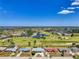Aerial view of a residential community with a golf course, showcasing the property's location and surrounding neighborhood at 142 Rotonda Cir, Rotonda West, FL 33947