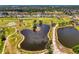 Scenic aerial view of golf course community featuring ponds, manicured greens, and a mix of residential homes at 142 Rotonda Cir, Rotonda West, FL 33947