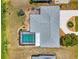Aerial view showcasing a private screened-in pool and a meticulously maintained roof of a single-Gathering home at 142 Rotonda Cir, Rotonda West, FL 33947