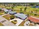 Lovely single-story home with meticulously manicured landscaping, a long driveway, and easy access to a golf course at 142 Rotonda Cir, Rotonda West, FL 33947