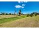 Expansive backyard featuring a mix of grass and natural vegetation, ideal for creating a serene outdoor retreat at 142 Rotonda Cir, Rotonda West, FL 33947