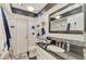 Stylish bathroom featuring a modern vanity with black countertop, tiled shower, and contemporary fixtures at 142 Rotonda Cir, Rotonda West, FL 33947