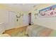 Cozy bedroom featuring bright yellow walls, tropical decor, and a closet with sliding doors at 142 Rotonda Cir, Rotonda West, FL 33947