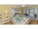 Cozy bedroom features bright natural light and patio access overlooking the pool at 142 Rotonda Cir, Rotonda West, FL 33947